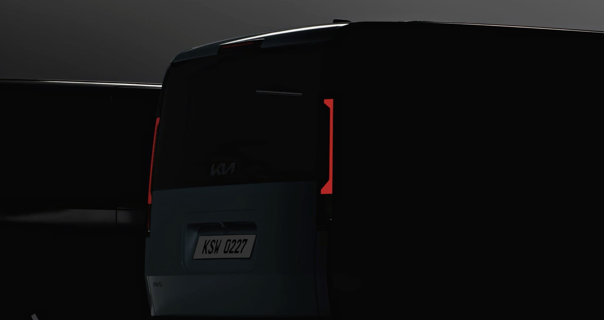Rear view of the Kia PV5 Cargo in low light, emphasizing the tail lamps 